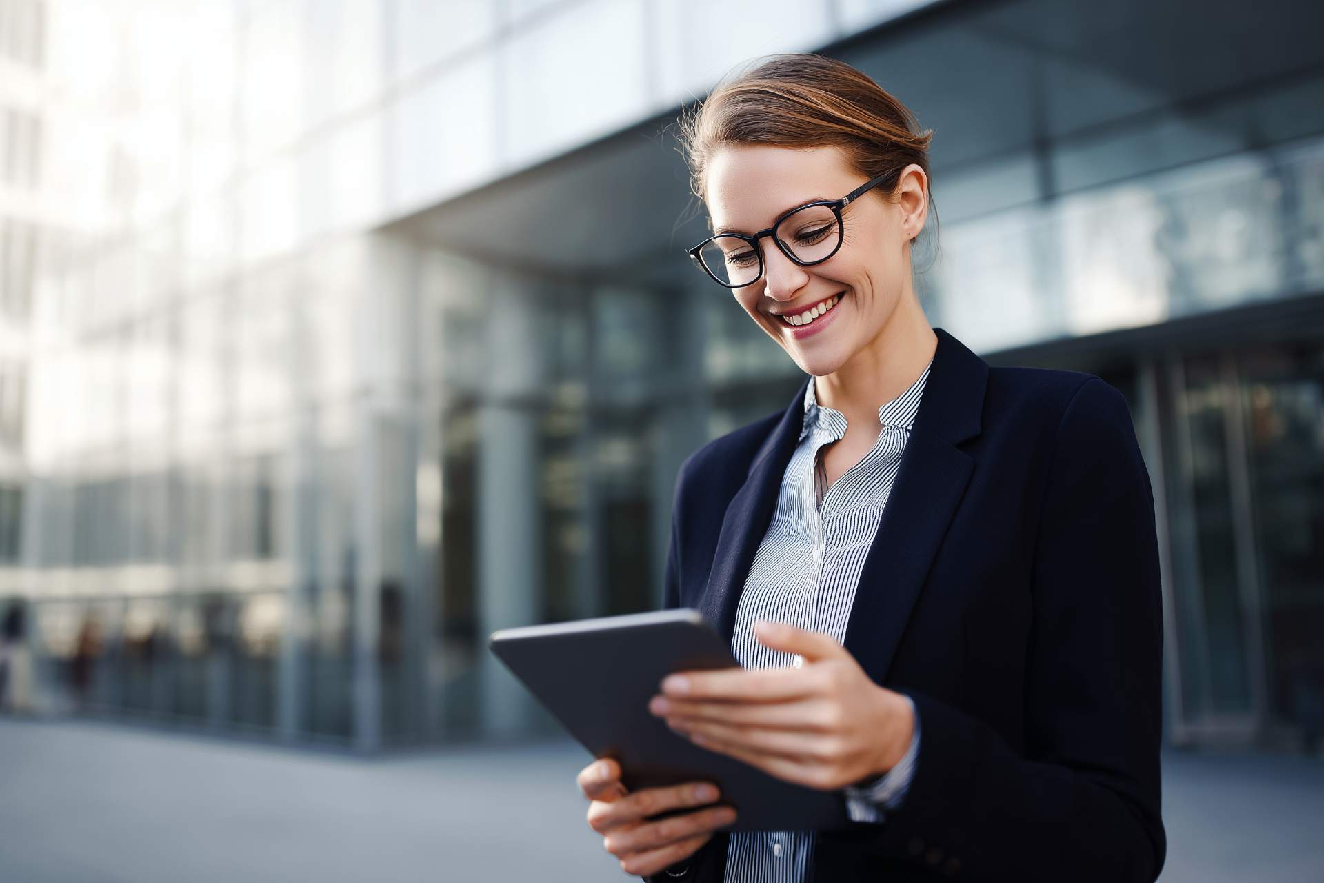 Executive reviewing performance metrics on a tablet outside a modern office